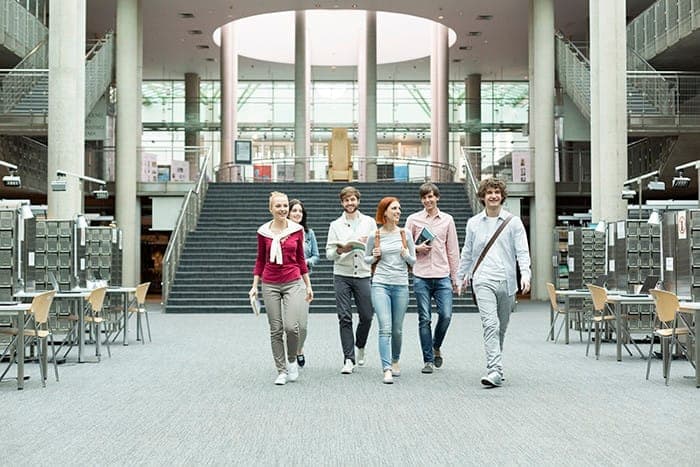 Students walking in a university library