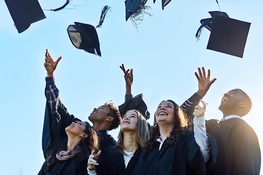 Students throwing graduation caps